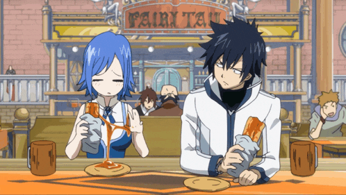 a couple of anime characters sitting at a table in front of a sign that says " fairy tail "