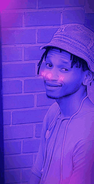 a man wearing a bucket hat with the word wow on his cheek