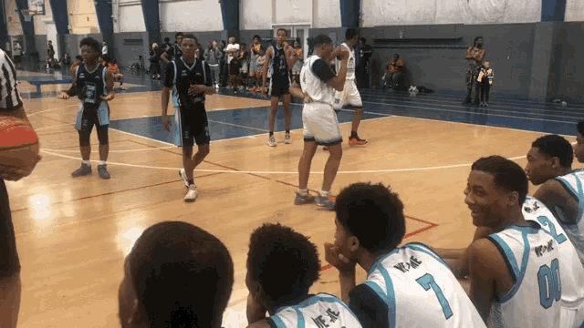 a basketball game is being played on a court with players wearing jerseys with the number 1 and 6 on them