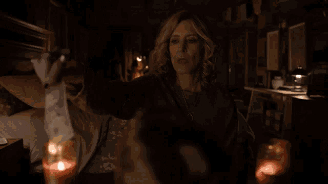 a woman is holding a piece of money that is on fire