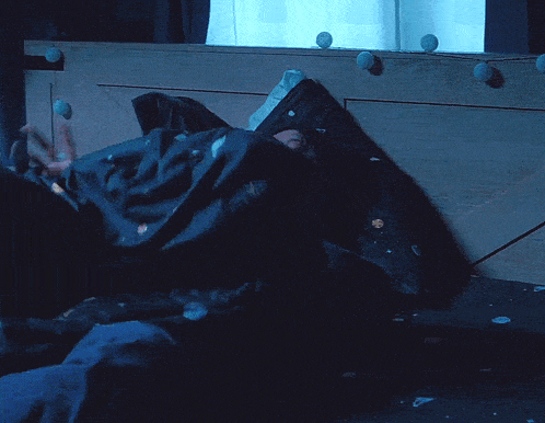 a person is laying on a bed looking at their phone