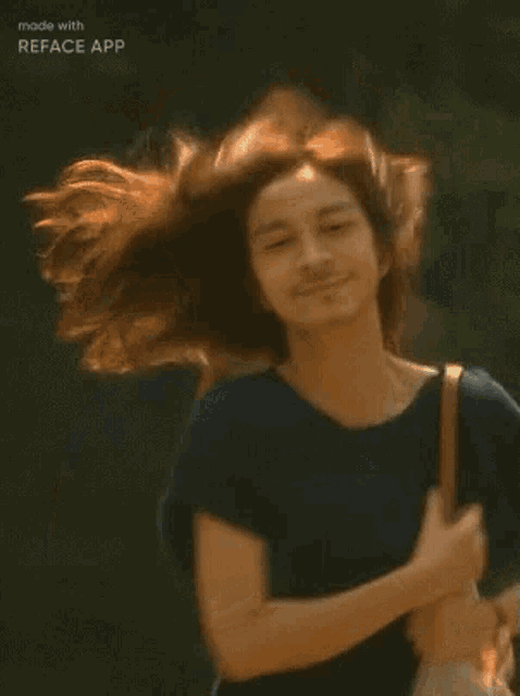 a woman with long hair and a beard is holding a purse while her hair blows in the wind .