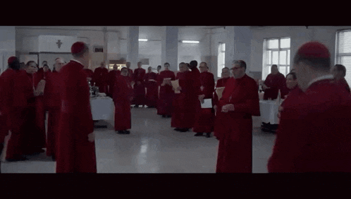 a group of priests are standing in a room