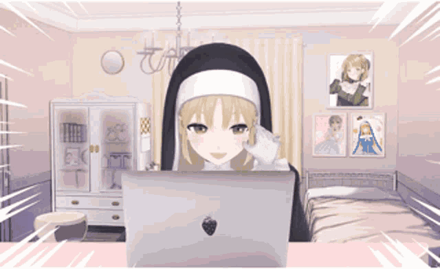 a nun is sitting in front of a laptop with a strawberry on it