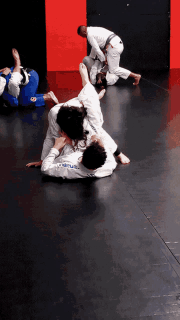 a group of people are practicing martial arts and one of their shirts says ' o'neill ' on it