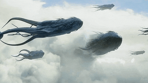 a group of whales are flying through the sky