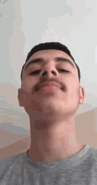 a young man with a mustache is making a funny face with his mouth open .