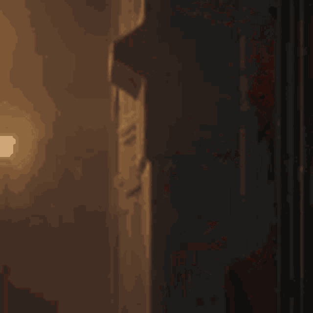 a close up of a person with red hair peeking out from behind a door .
