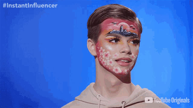 a person with a painting on their face and the words instantinfluencer
