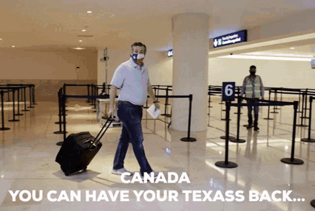a man wearing a mask and carrying a suitcase walks through an airport terminal with the words canada you can have your texass back
