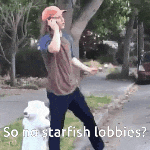 a man talking on a cell phone next to a fire hydrant with the words so no starfish lobbies below him