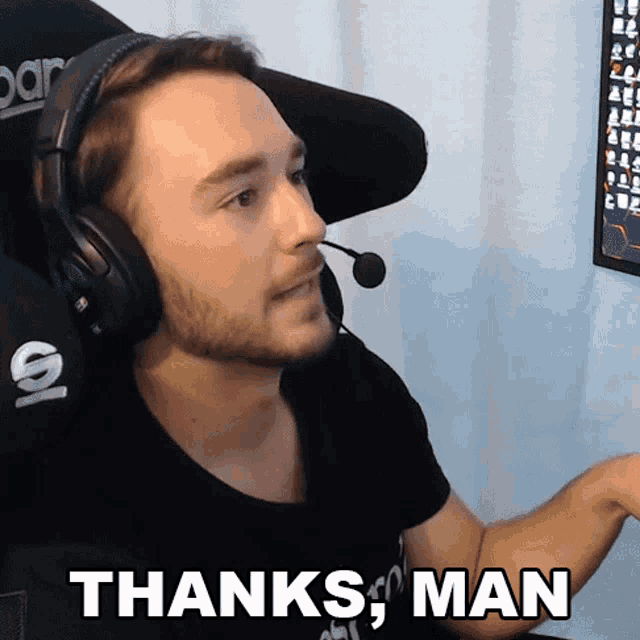 a man wearing headphones says thanks man in front of a monitor
