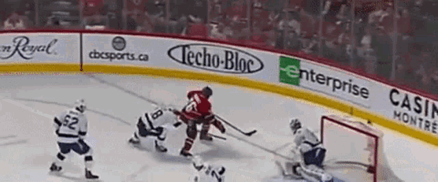 a hockey game is being played with advertisements for techo-bloc enterprise and casino