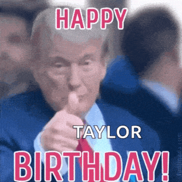 a man in a suit and tie is pointing at the camera and saying `` happy birthday taylor '' .