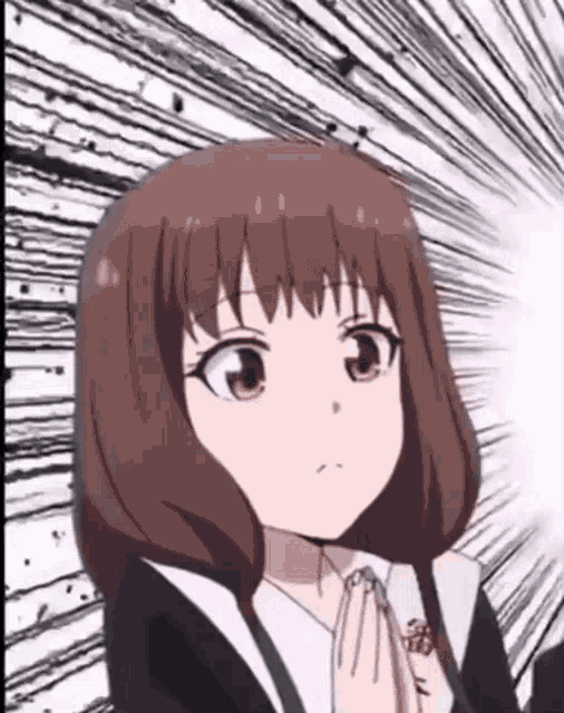 a close up of a girl 's face with her hands folded in front of her face .