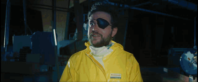 a man wearing a yellow jacket that says honeywell on the front