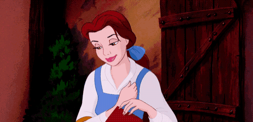 belle from beauty and the beast is wearing a blue apron and white shirt