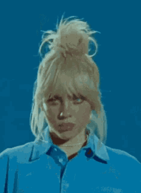 a close up of a woman 's face with a blue background .