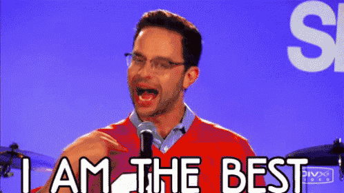 a man is standing in front of a microphone and saying i am the best