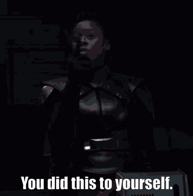 a woman in a black suit says " you did this to yourself " in a dark room