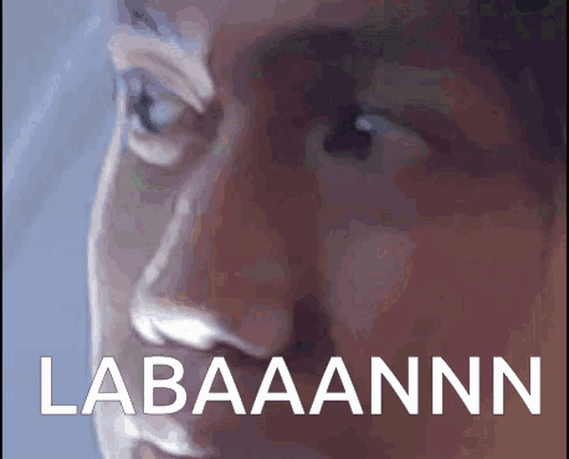 a close up of a man 's face with the word labaaannn written below it