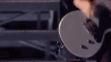 a close up of a person playing an electric guitar .