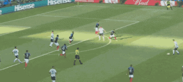 a soccer game is being played on a field with hisense advertisements