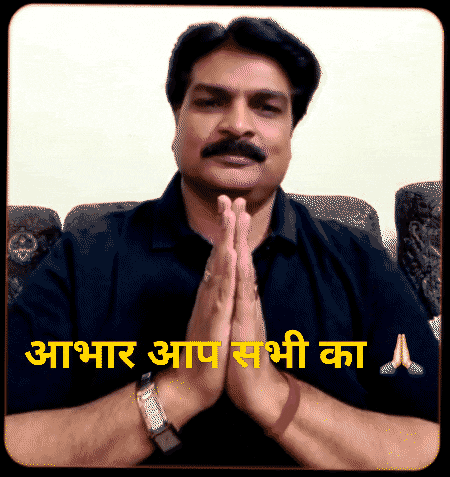 a man with a mustache is praying with his hands folded in front of a sign that says " आप सभी का "