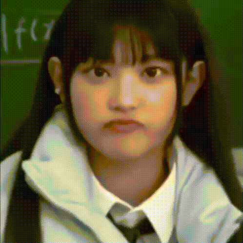 a girl wearing a white shirt and tie is making a face