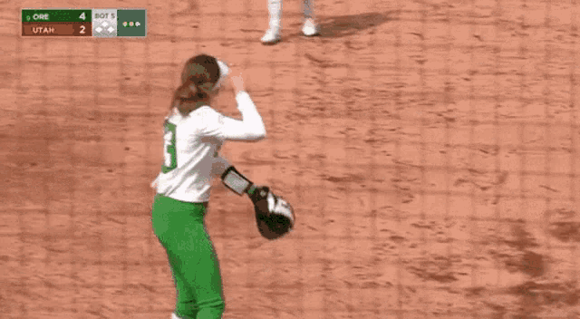 a female softball player with the number 13 on her jersey