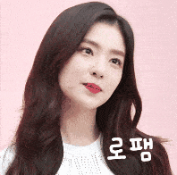 a close up of a woman 's face with korean writing on the bottom