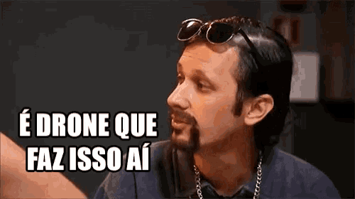 a man with a beard wearing sunglasses is talking in a foreign language .