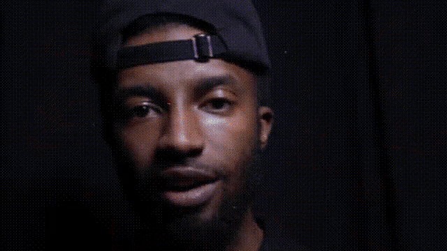 a close up of a person 's face with a black background