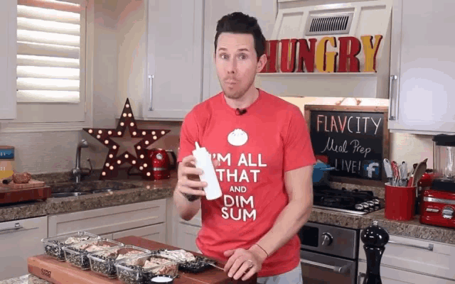 a man wearing a red t-shirt that says i 'm all that and dim sum