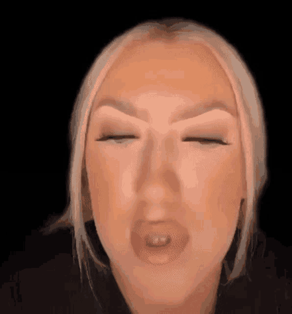 a close up of a woman 's face with her eyes closed .
