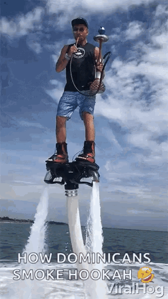 a man smoking a hookah while riding a jet ski