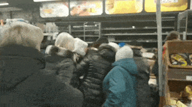 a group of people are standing in a line in front of a sign that says ' spar '