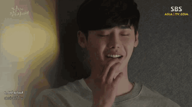 a man with his eyes closed and a sbs asia tv logo in the corner