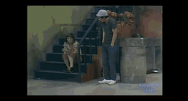 a man standing next to a woman sitting on stairs .