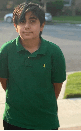 a young boy is wearing a green polo shirt with a yellow pony on it