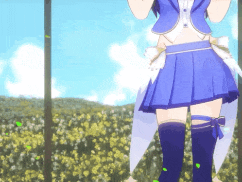 a girl in a blue skirt stands in a field of flowers