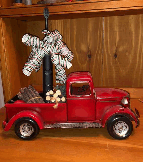 a red truck with a toothbrush and a toothbrush holder