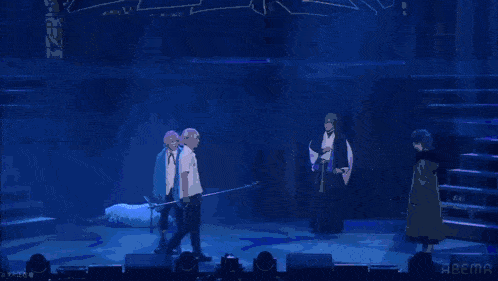 two men are standing next to each other on a stage with a blue background .