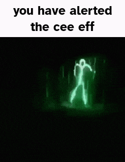 a ghost is standing in a dark room with a green light behind it .