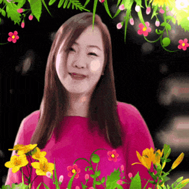 a woman in a pink shirt is surrounded by flowers on a black background