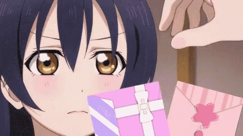 a girl is looking at a pink gift box with a white ribbon and a flower on it