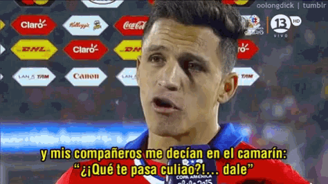 a soccer player with a black spot on his face is talking to someone