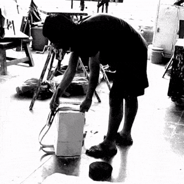 a black and white photo of a man kneeling down