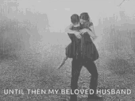 a man is carrying a woman on his shoulders .