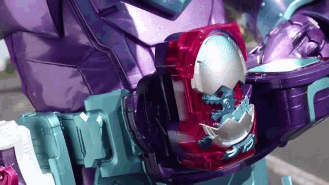 a person in a purple and blue costume is holding a red object in their right hand .